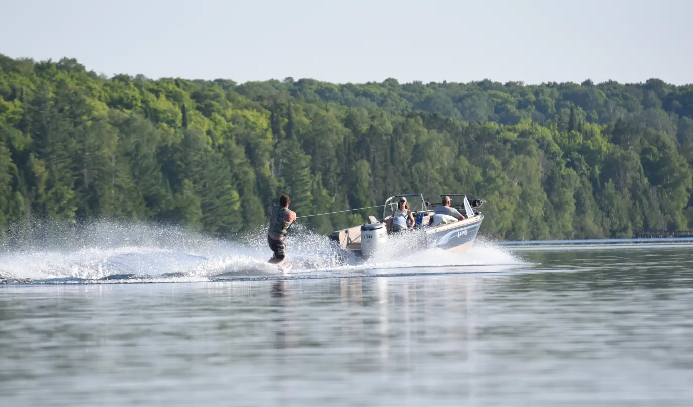 Waterskiing on lake in township